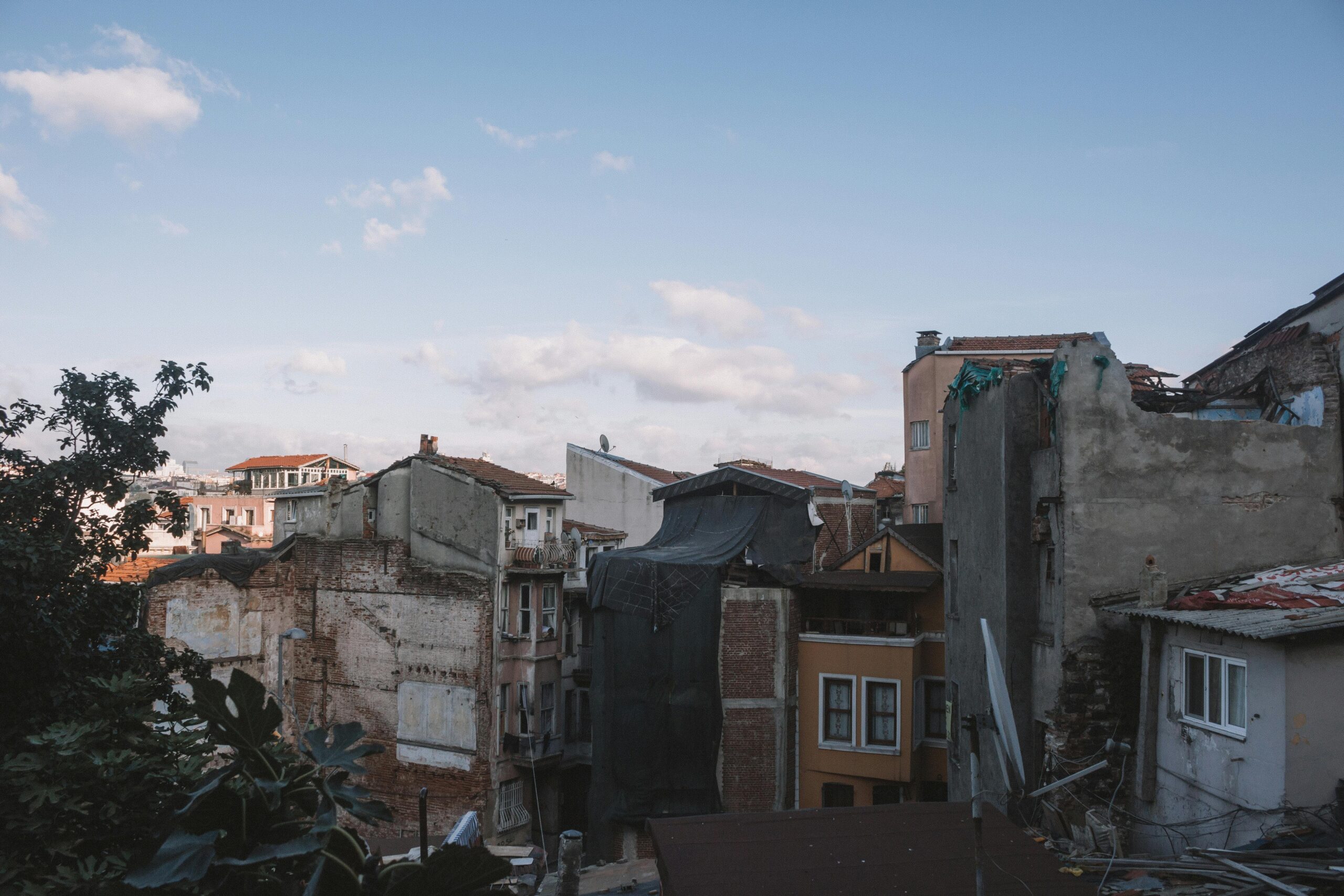 View of decaying urban structures under a clear blue sky, depicting architectural decline.