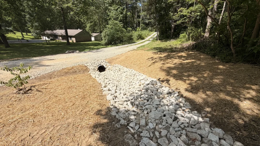 Gravel driveway with culvert and riprap channel built by Alchemy Excavation